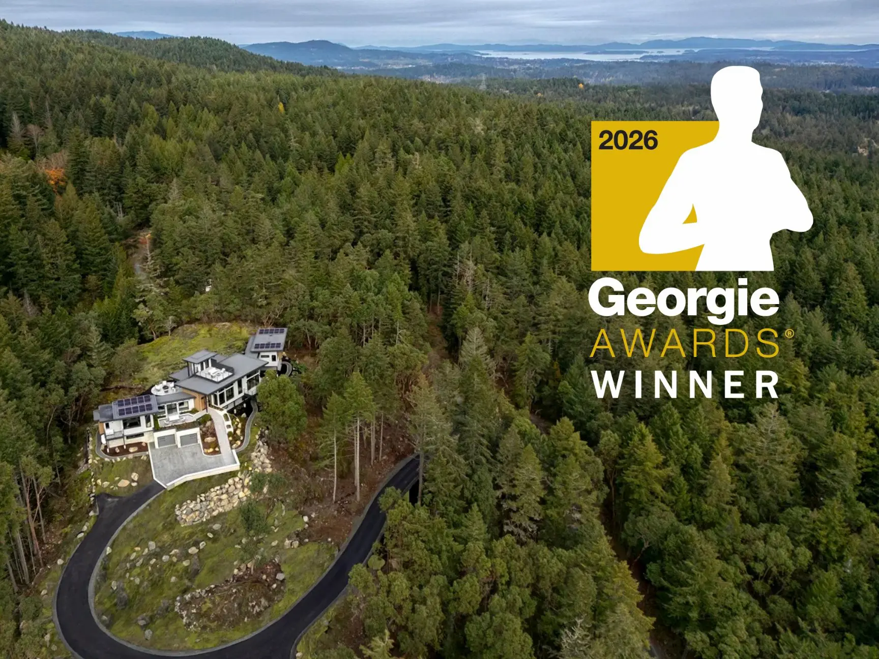 The Perch house nestled in dense forest with a winding driveway. Overlay text reads 2026 Georgie Awards Winner beside the silhouette of a person in a gold square.