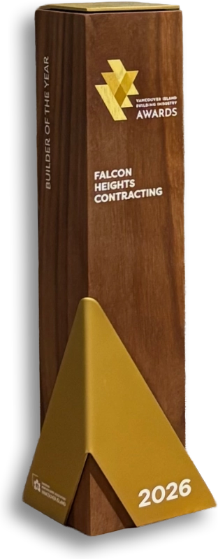 A wooden award trophy with gold accents, labeled Vancouver Island Building Industry Awards. Text reads Builder of the Year, Falcon Heights, and the year 2026 in gold at the base.